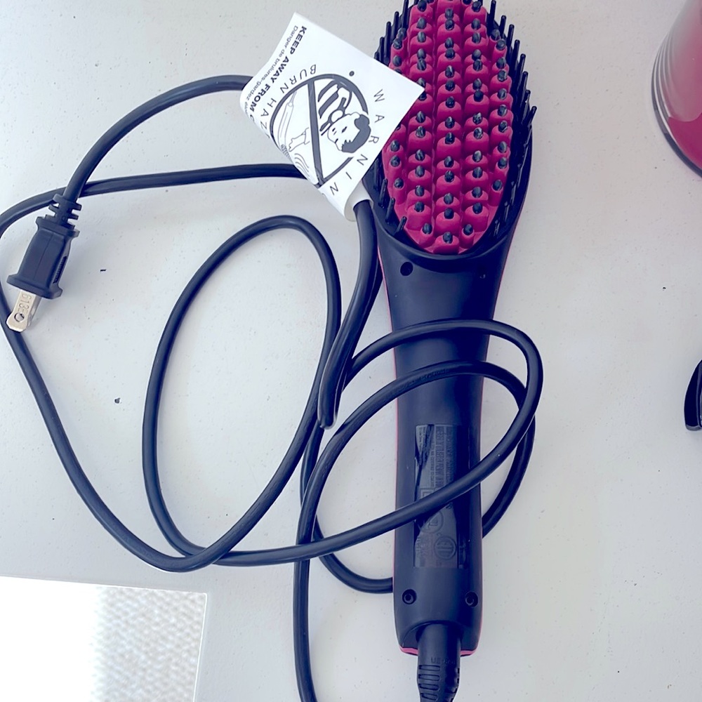 Hair tool that heats up & straightens your hair. Has adjustable heat settings.